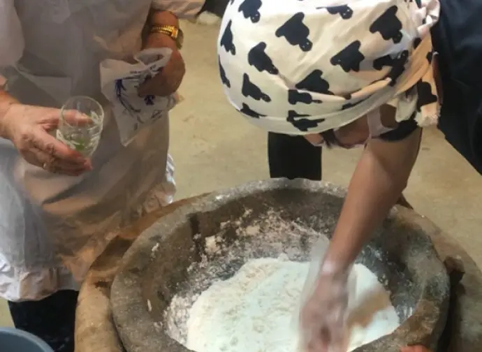 A woman kneading dough