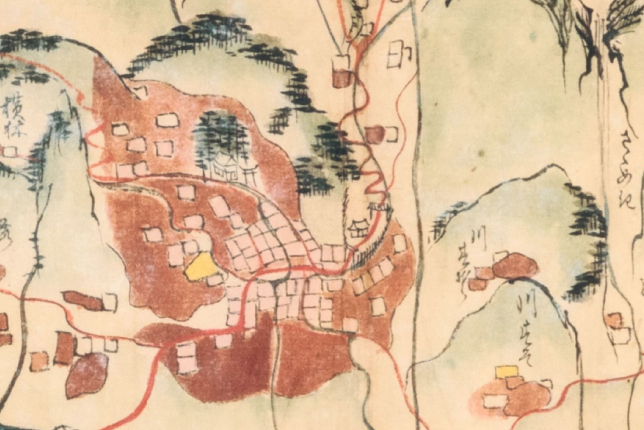 An old hand-drawn map illustrating a traditional mountain village with roads and buildings.